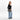 A woman wearing a Sherpani Ceara Ciao Expandable Crossbody on her shoulder against a white background.   #color_ciao-print