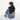 Woman wearing a Sherpani Hyk Dune Hip Pack across her back against white backdrop. #color_dune-tan