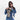 Woman holding a Sherpani Izzie Dune Water Bottle Crossbody by handheld straps on white background.   #color_dune-tan