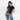 Woman wearing a Sherpani Zoom Dune Slim RFID Crossbody against white background. #color_dune-tan