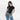Woman wearing a Sherpani Zoom Oiivne Slim RFID Crossbody against white background. #color_olivine-green