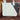 A woman packs a Sherpani Jetsetter Terrazzo Print Travel Tote Bag with various items, such as a laptop, water bottle, and more. 