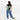 Woman wearing a Sherpani Esprit Olivine Sling on her back against white backdrop. #color_olivine-green