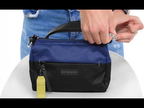 A short video of a blonde model showcasing the features of Sherpani's purse, the Skye in Pacific Blue. #color_cider